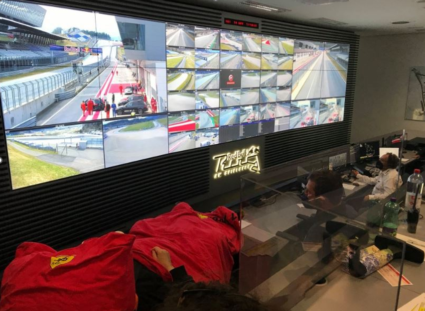 Race control room for motorsport with timing and camera feeds on a video wall